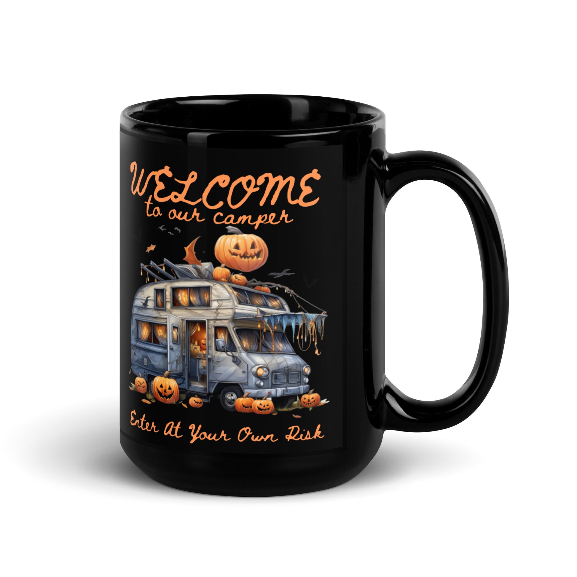 A black glossy ceramic mug with a Halloween-themed design featuring text and an illustration of a camper, pumpkins, and bats.